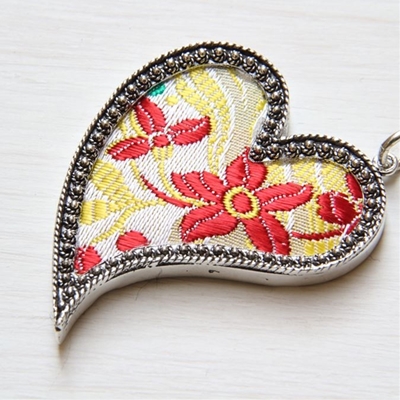 Silver heart pendant with red brocade