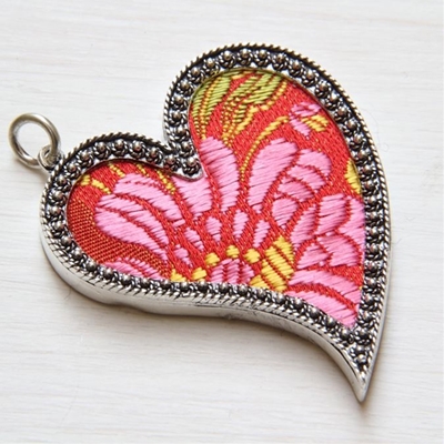 Silver heart pendant with red brocade